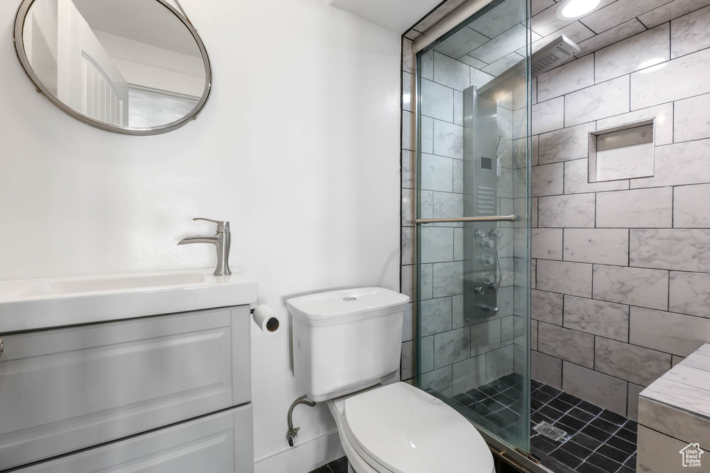 Bathroom featuring vanity and a stall shower