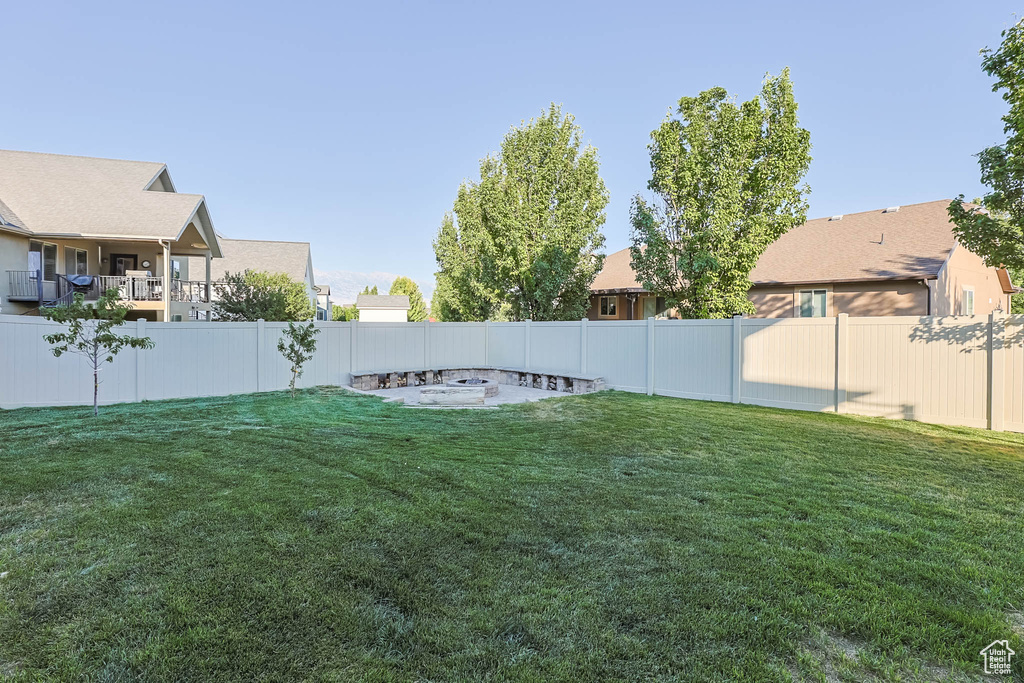 Fenced backyard featuring a residential view