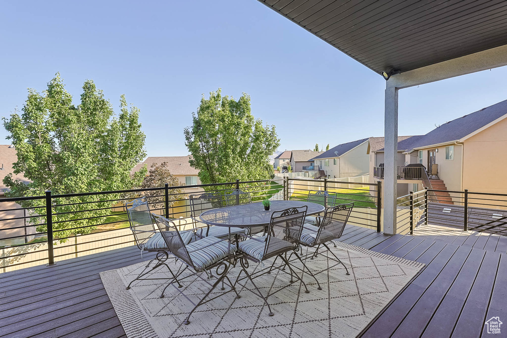 Wooden deck with a residential view and outdoor dining area