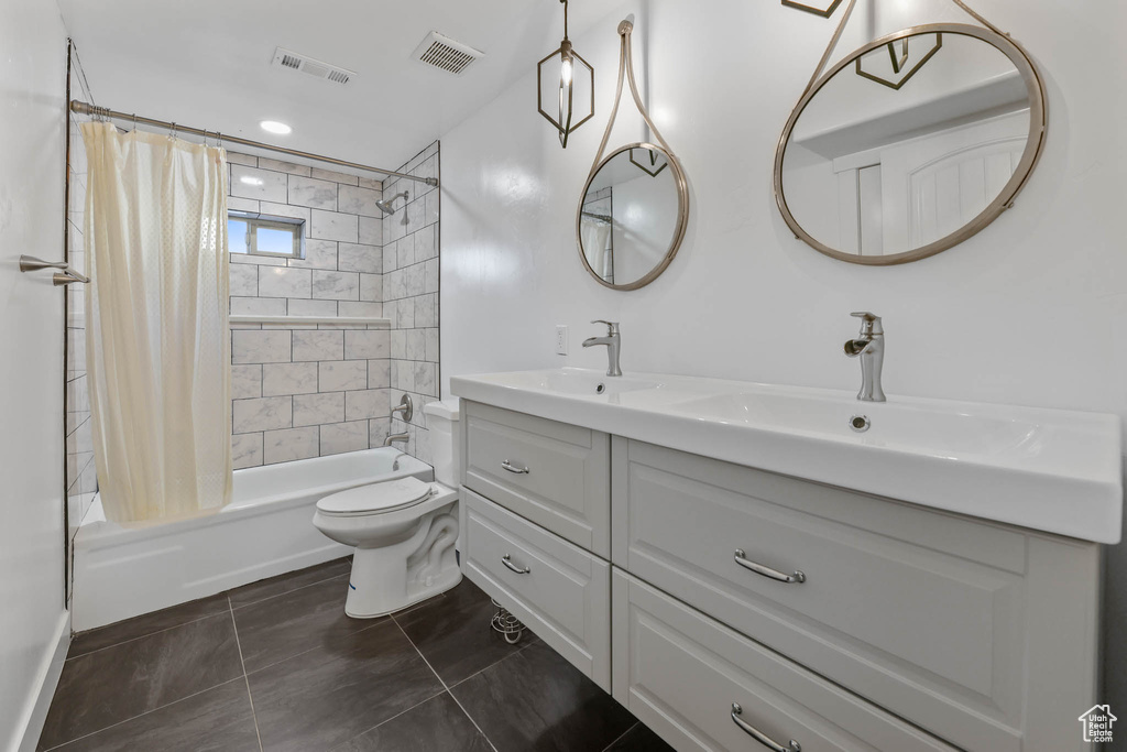 Full bath featuring shower / tub combo, double vanity, and tile patterned floors