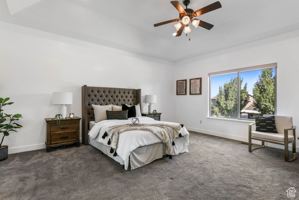 Bedroom featuring dark colored carpet and a ceiling fan