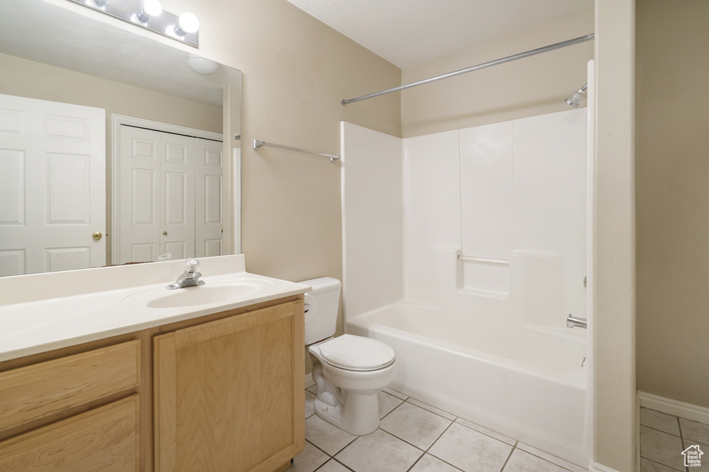 Bathroom featuring tile patterned flooring, vanity, and bathtub / shower combination