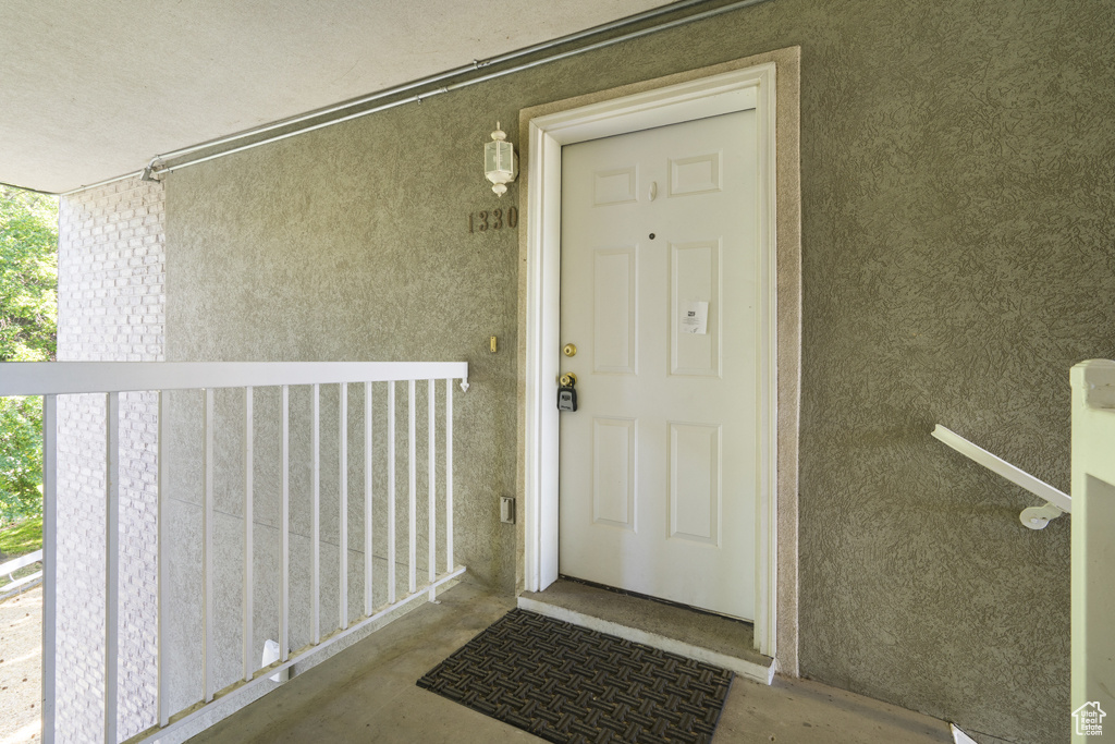Entrance to property with stucco siding