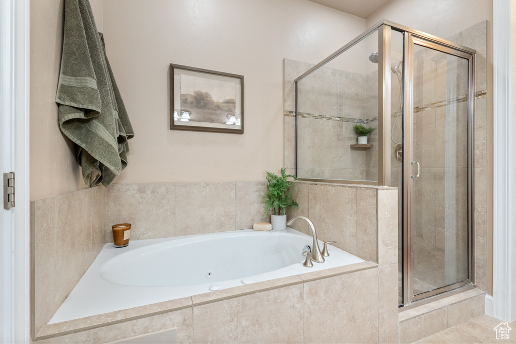 Bathroom with a jetted tub and a shower stall
