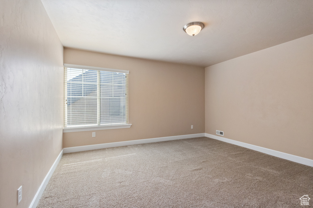 Spare room featuring carpet