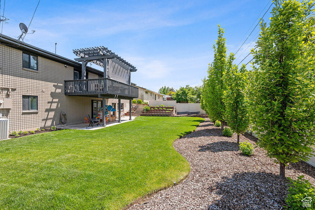 View of yard with a pergola, a patio, and a deck