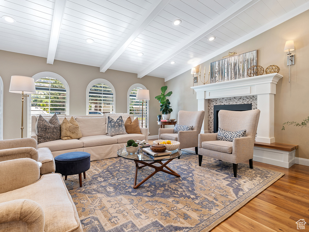 Living room with wood finished floors, healthy amount of natural light, a tile fireplace, and recessed lighting