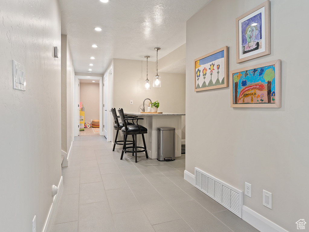 Hallway featuring recessed lighting and tile patterned flooring