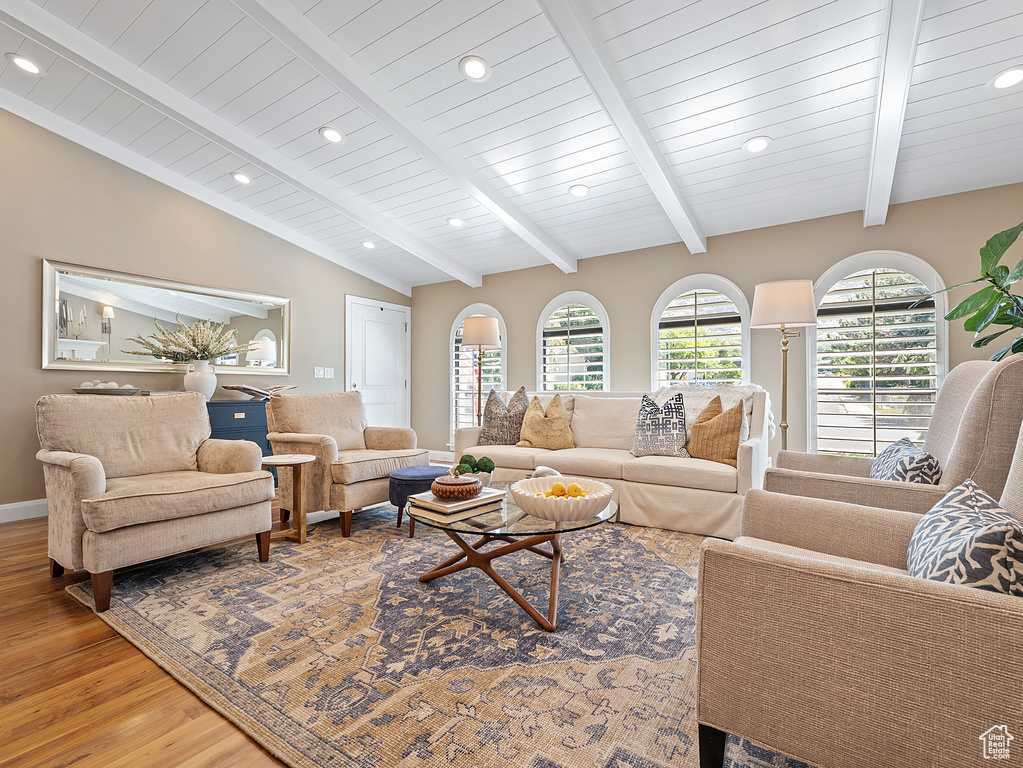 Living room with light wood finished floors and recessed lighting
