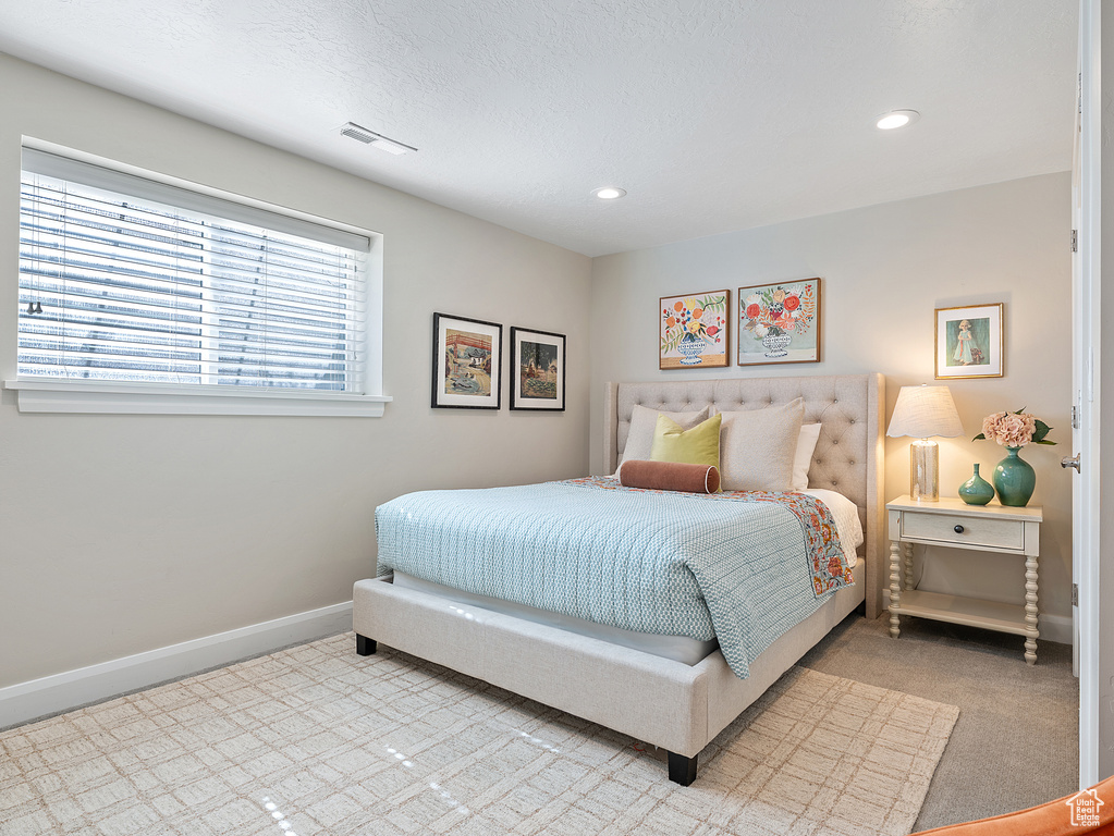 Bedroom featuring light carpet and recessed lighting
