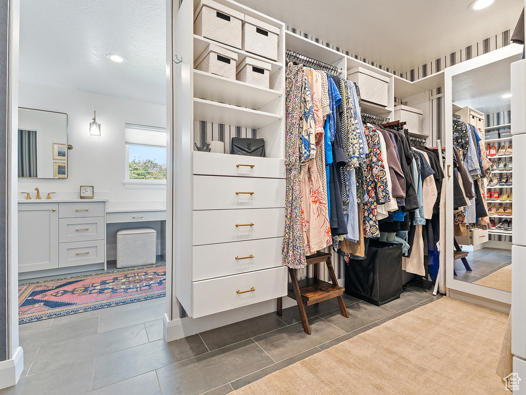 Spacious closet with a sink and tile patterned floors