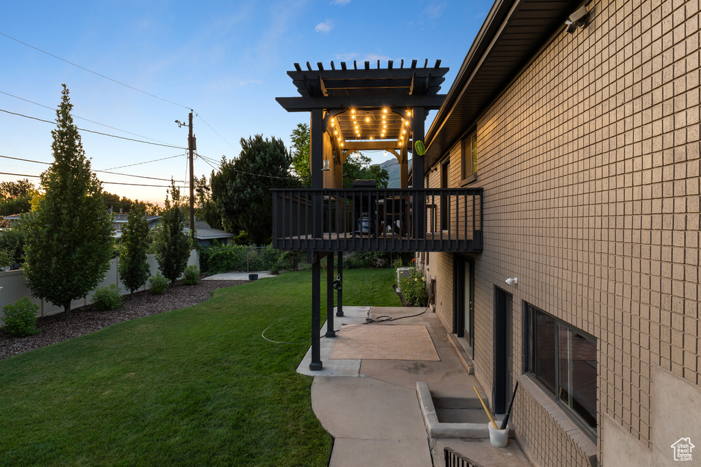 View of yard with a patio, a wooden deck, and a pergola