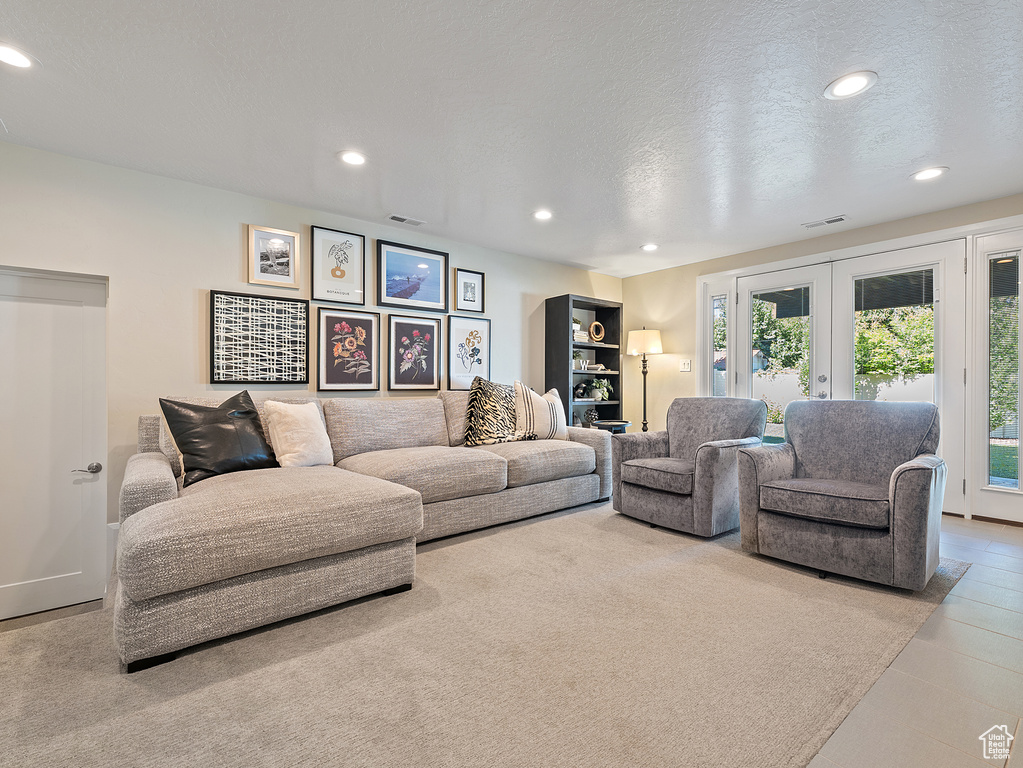 Living room featuring french doors, recessed lighting, and a textured ceiling