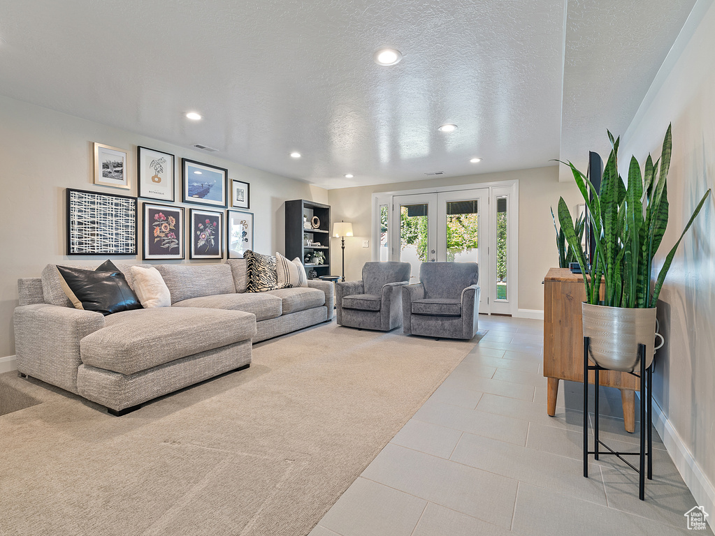 Living room with recessed lighting, tile patterned floors, and a textured ceiling