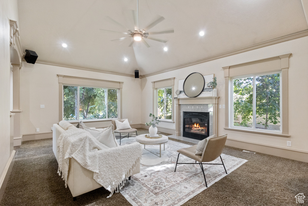 Living area featuring a premium fireplace, carpet, a ceiling fan, ornamental molding, and recessed lighting