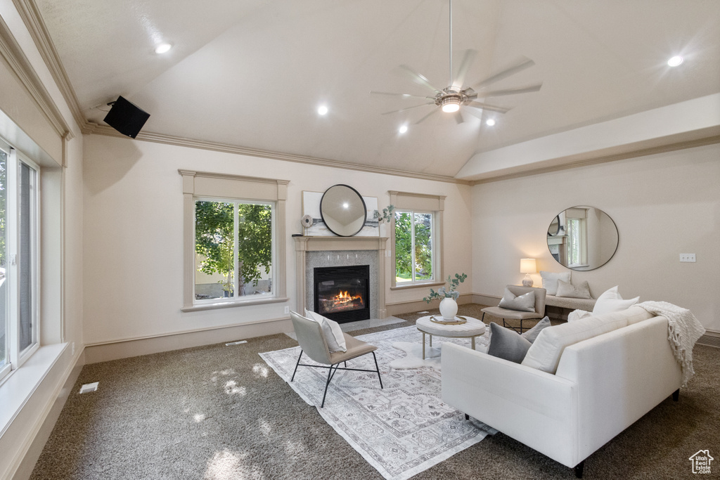 Living area with vaulted ceiling, a ceiling fan, a premium fireplace, carpet, and recessed lighting