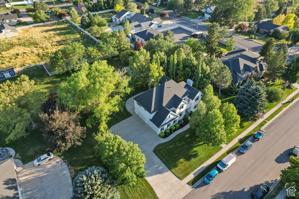 Aerial overview of property\\\'s location featuring nearby suburban area and a tree filled landscape