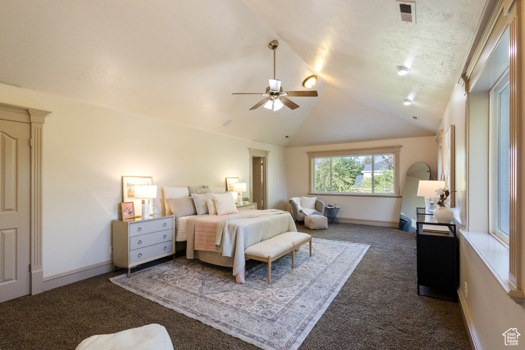 Bedroom featuring carpet, lofted ceiling, and a ceiling fan