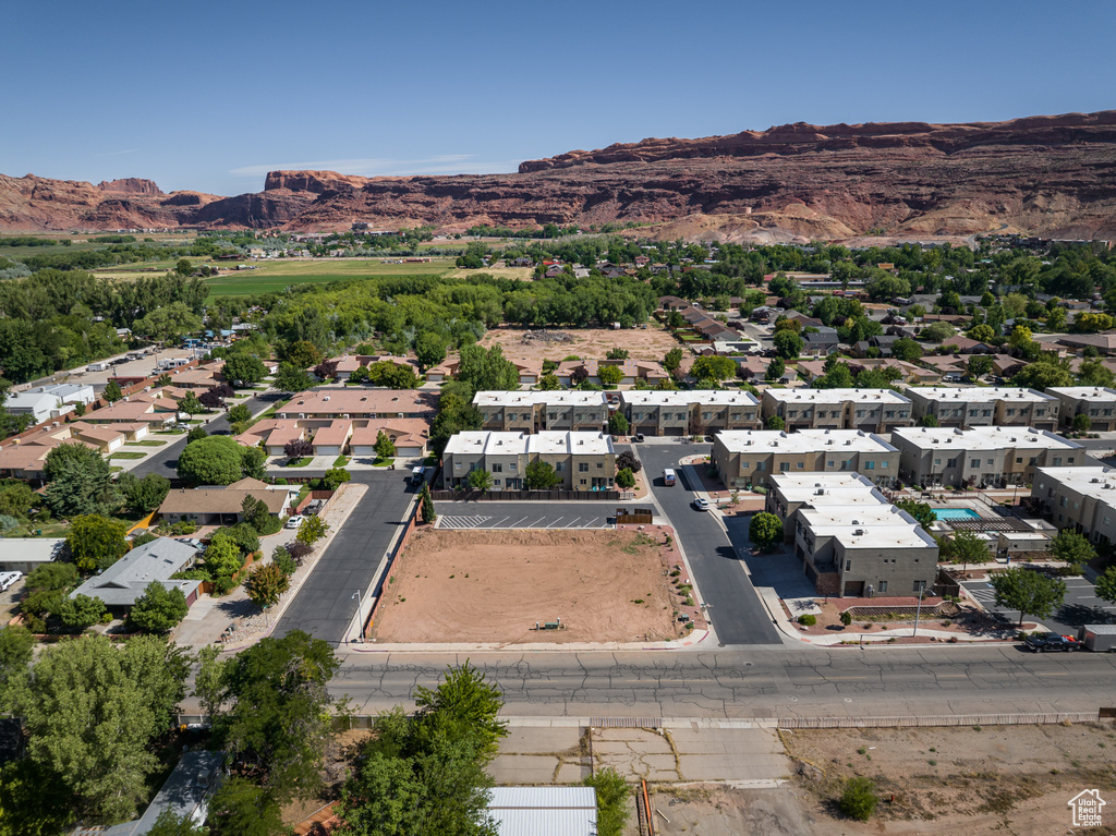View of property location featuring mountains and nearby suburban area