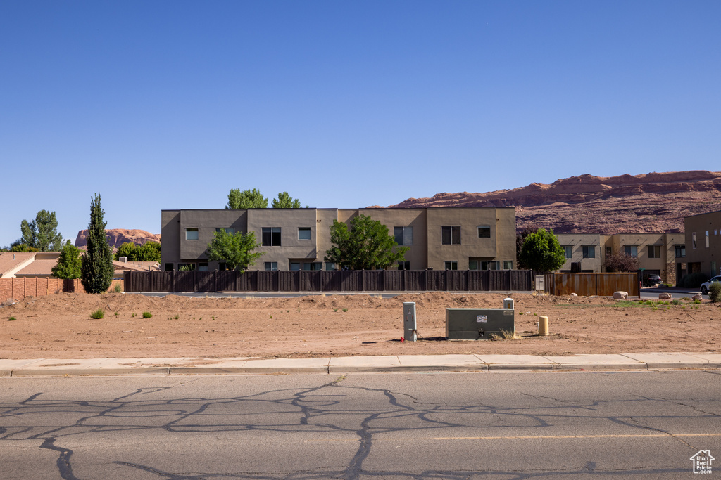 Pueblo revival-style home with a mountain view and a residential view