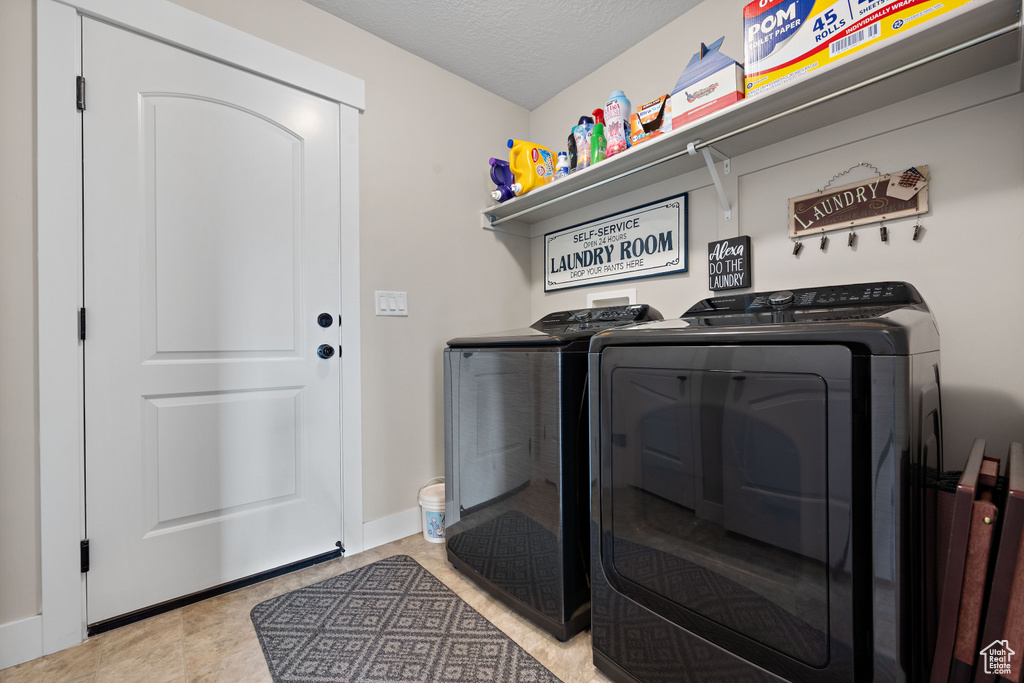 Laundry room with separate washer and dryer and baseboards