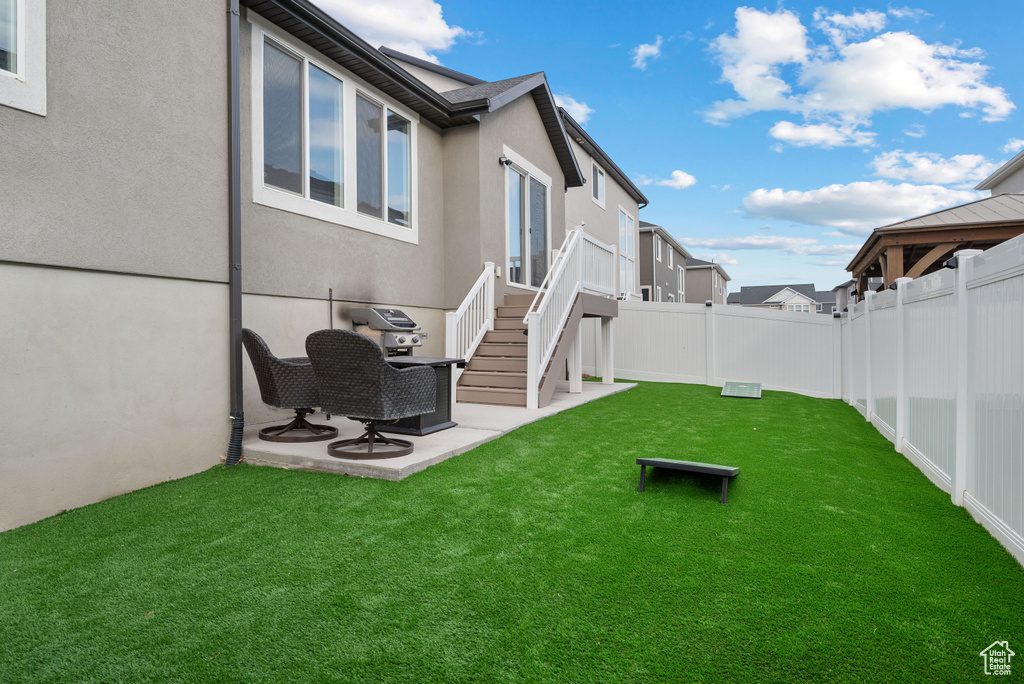 Fenced backyard featuring a patio
