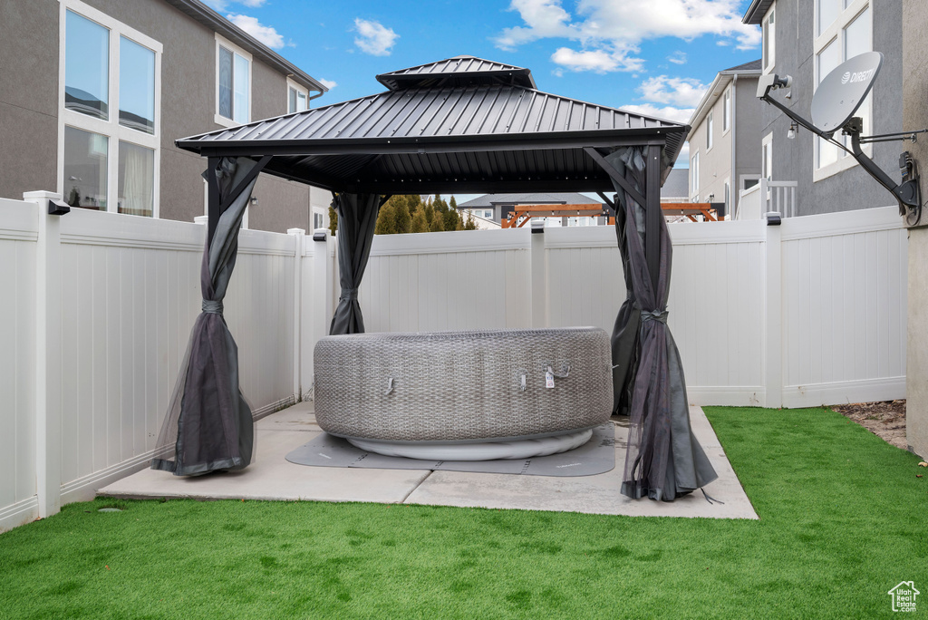 Fenced backyard with a gazebo