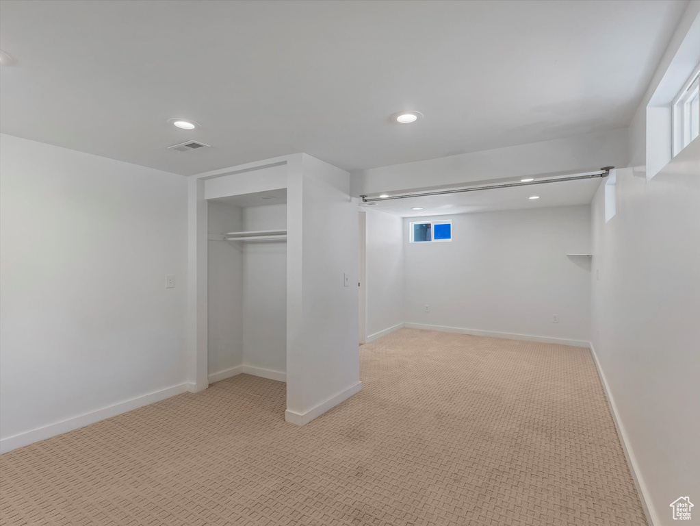 Below grade area featuring light carpet and recessed lighting