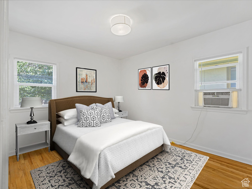 Bedroom featuring cooling unit and light wood-type flooring