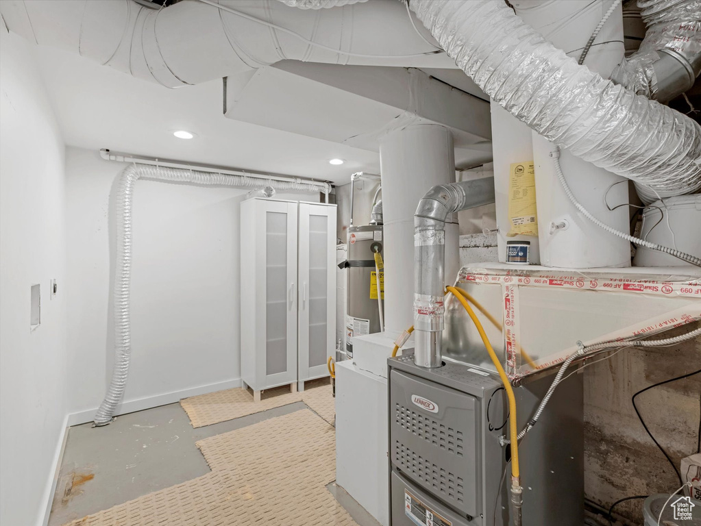Utility room featuring secured water heater