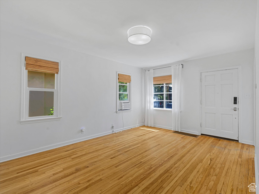 Unfurnished room with light wood-style flooring and cooling unit
