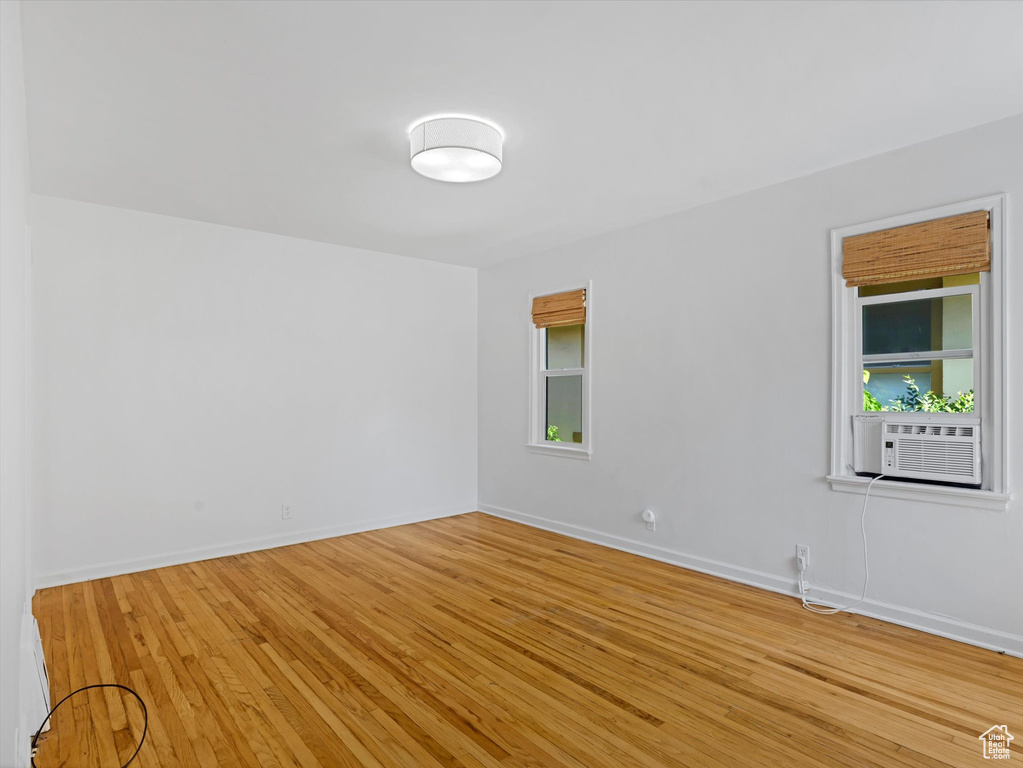 Spare room with hardwood / wood-style floors and plenty of natural light