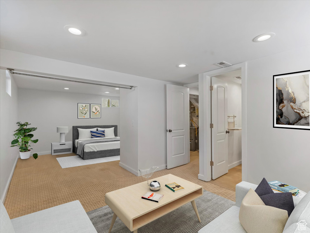 Living area featuring light colored carpet and recessed lighting