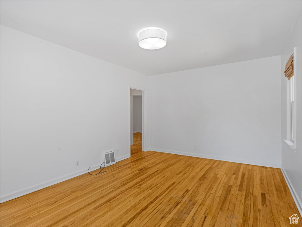 Unfurnished room with light wood-style flooring and baseboards