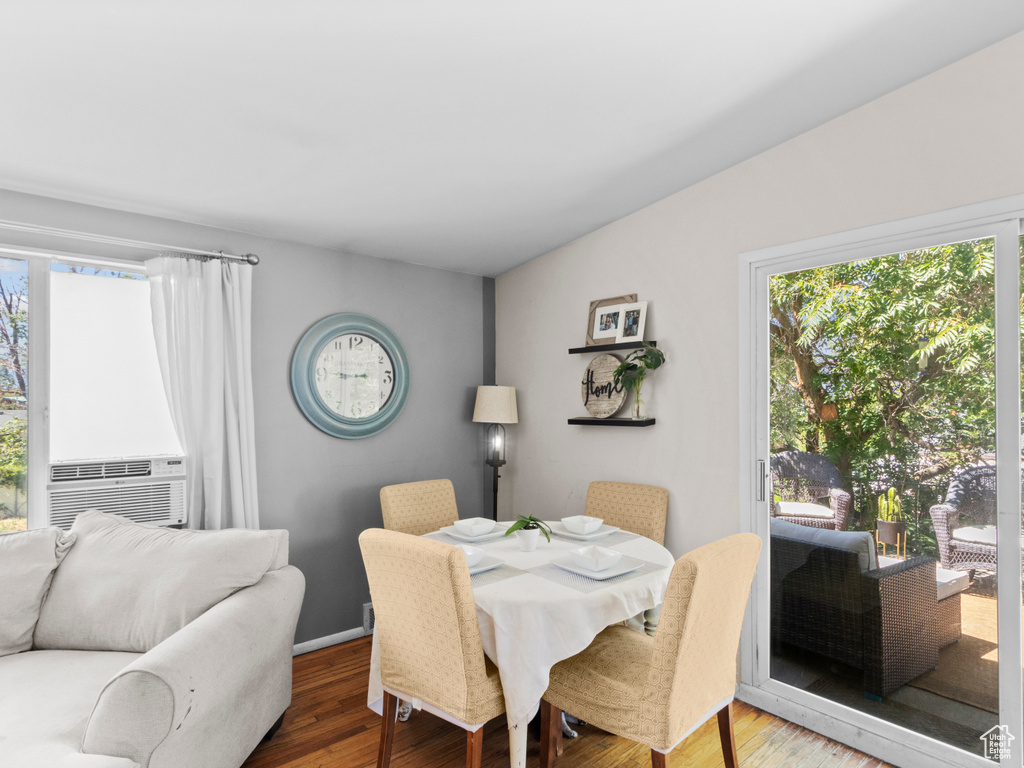 Dining space featuring plenty of natural light, wood finished floors, and cooling unit