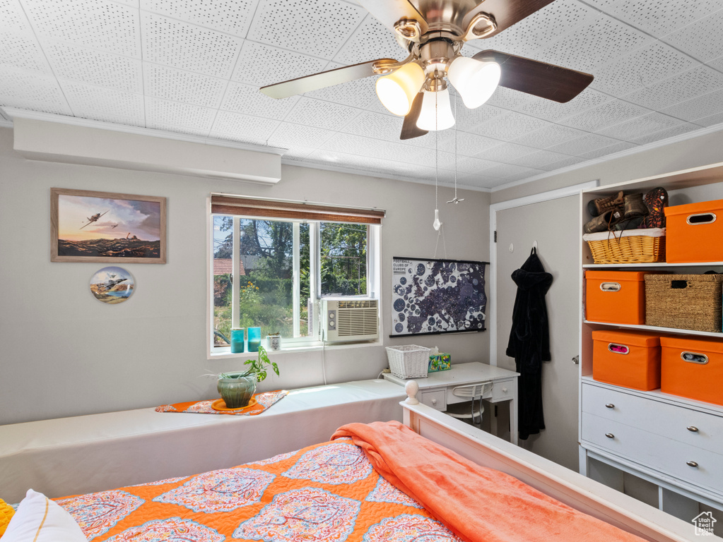 Bedroom featuring ornamental molding, a ceiling fan, and cooling unit