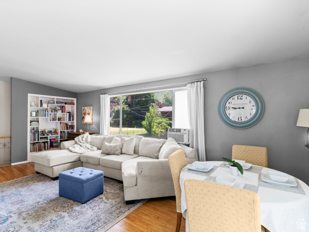 Living area featuring wood finished floors and cooling unit