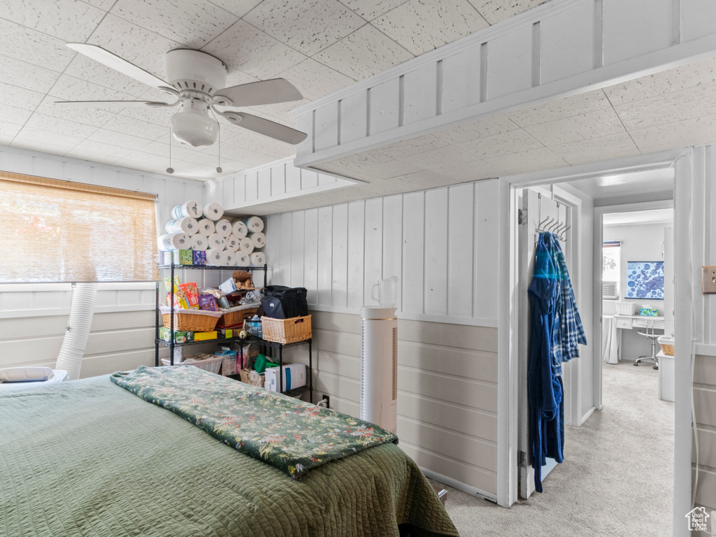 Bedroom featuring light colored carpet and a ceiling fan