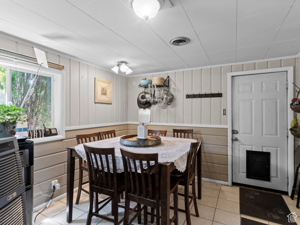 Dining space featuring light tile patterned floors and heating unit