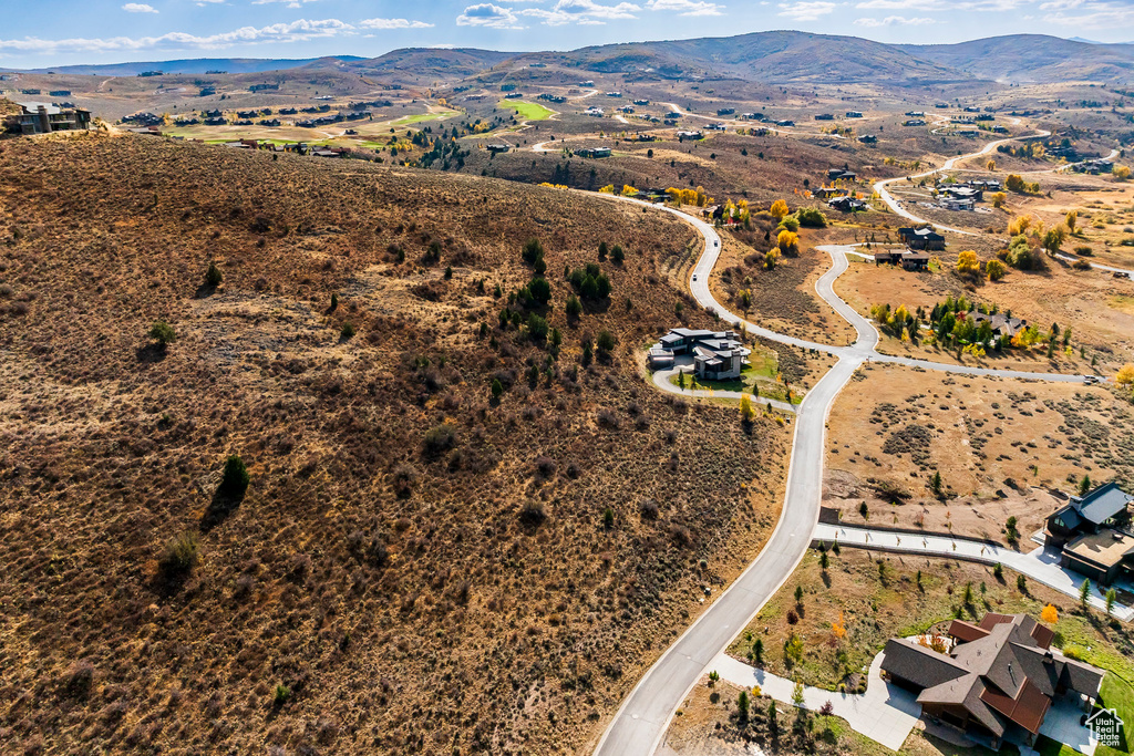 Aerial view of property's location featuring a mountain backdrop