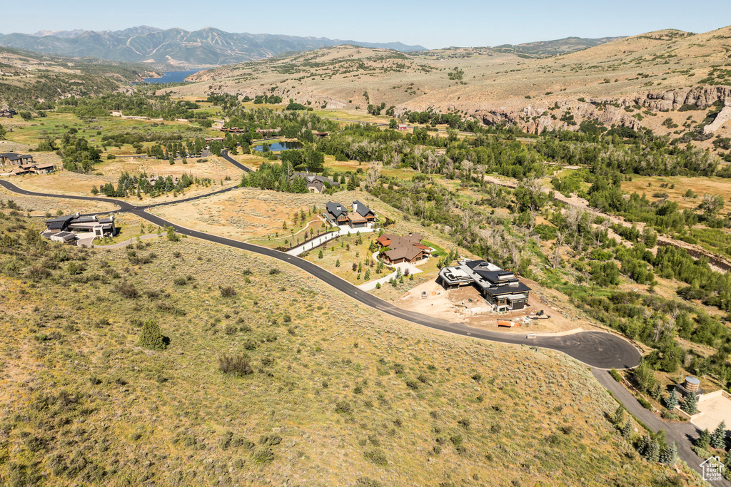 Aerial view of property and surrounding area with a mountainous background