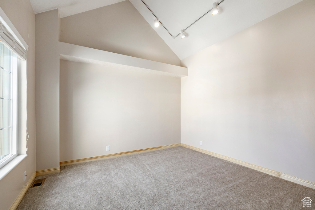 Additional living space featuring vaulted ceiling and carpet flooring
