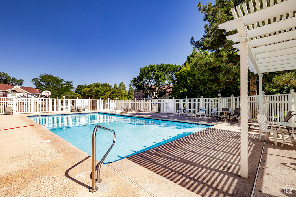 Community pool featuring a patio