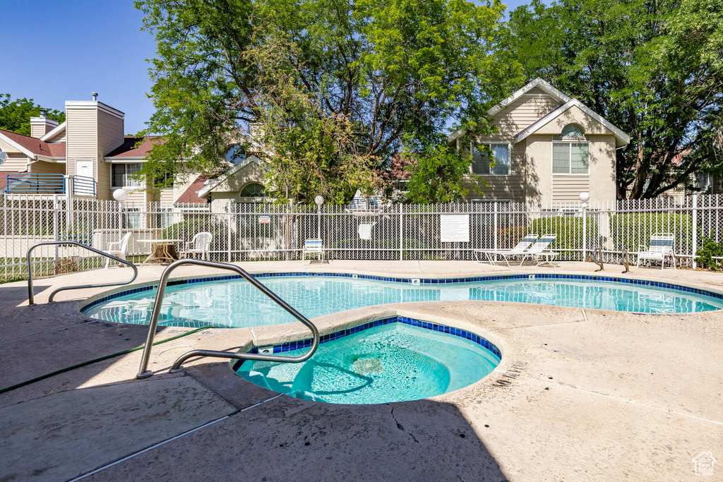 Community pool featuring a patio and a community hot tub