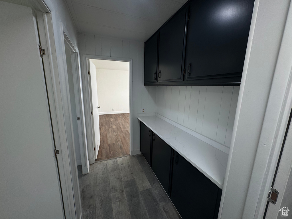 Laundry area with light wood-style floors