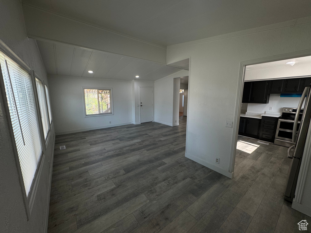 Unfurnished living room with dark wood-style flooring and recessed lighting