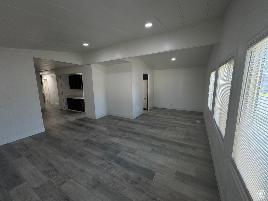 Unfurnished living room with dark wood-style flooring and recessed lighting