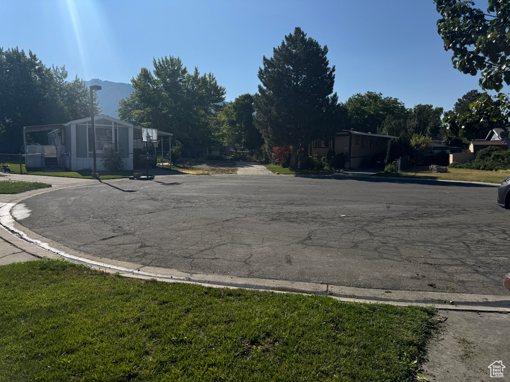 View of asphalt road featuring curbs