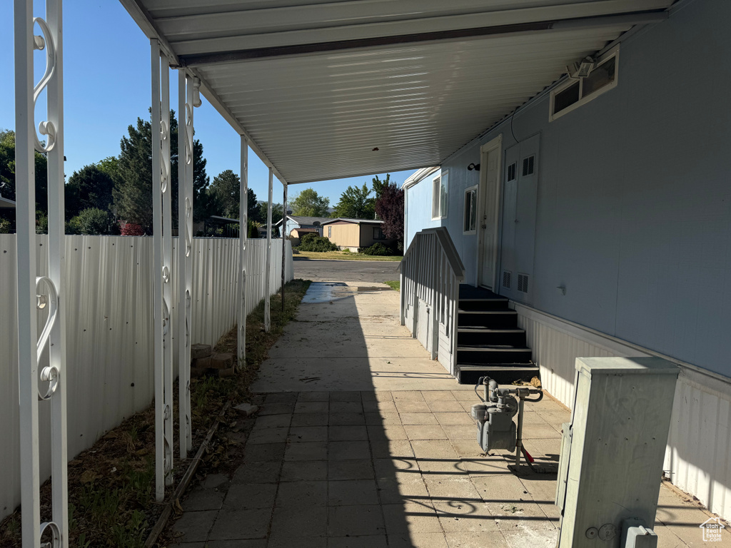 View of patio with a carport