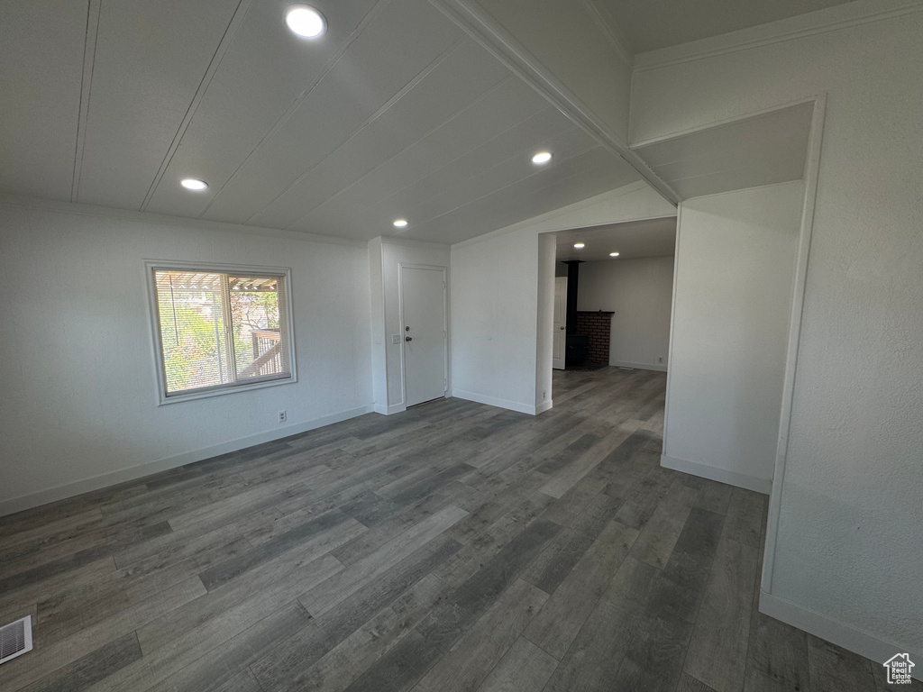 Spare room featuring dark wood-type flooring and recessed lighting